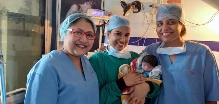 Aashirwad Hospital team with newborn and happy parents