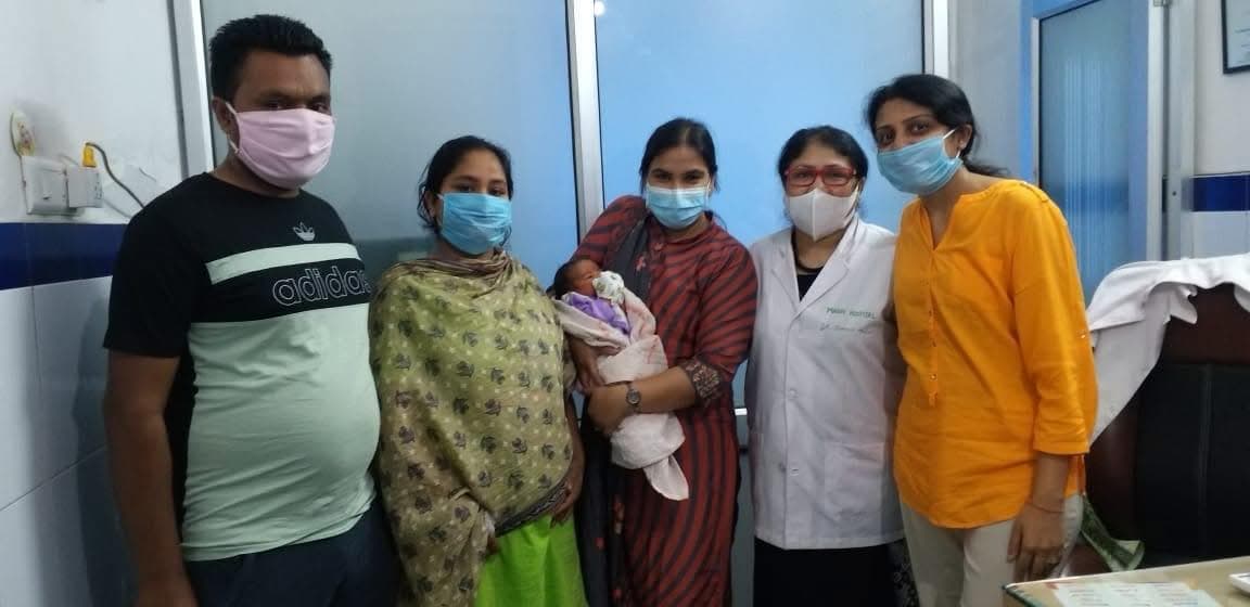 Happy family with newborn and hospital staff at Aashirwad Hospital